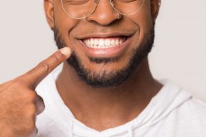 man smiling and pointing 