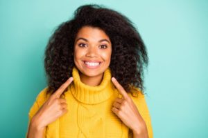 woman pointing to her smile after professional teeth whitening