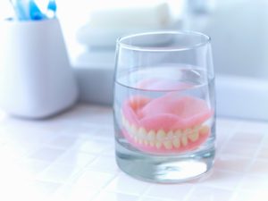 dentures sitting in a glass of water