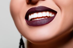 smiling woman with purple-based lipstick