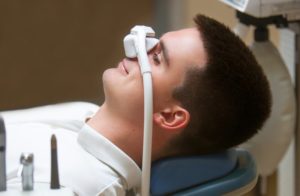 smiling man with a nasal mask on his face