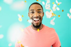 man smiling with confetti in the air