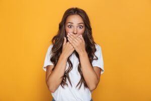 woman covering her mouth is surprise