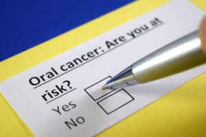 pen and a form with a question about your risk for oral cancer